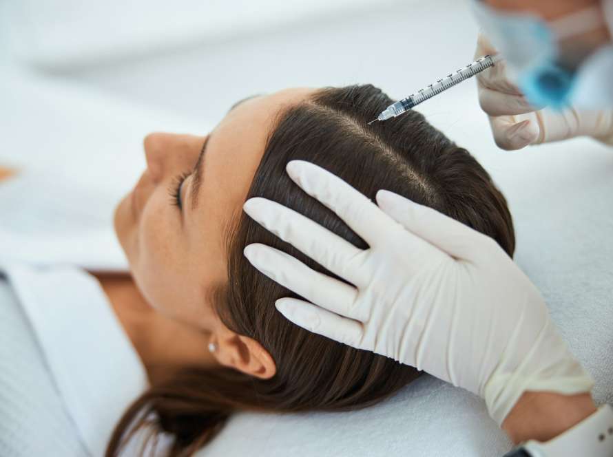 Young woman getting the serum scalp injection