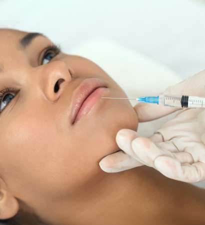 Close-up of aesthetic procedure on face for black lady